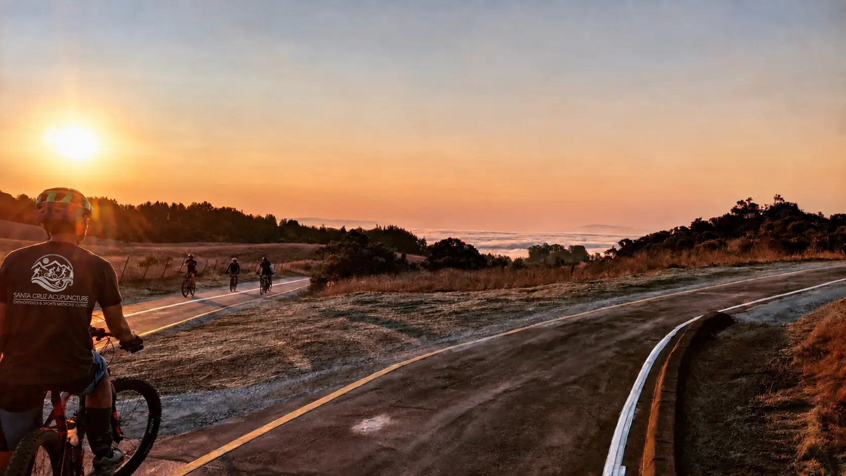 Mountain bikers riding at sunset above Santa Cruz