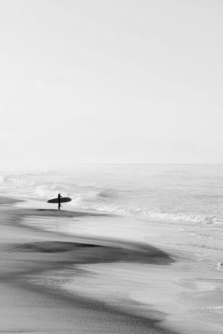 Black and white Santa Cruz beach scene with surfer